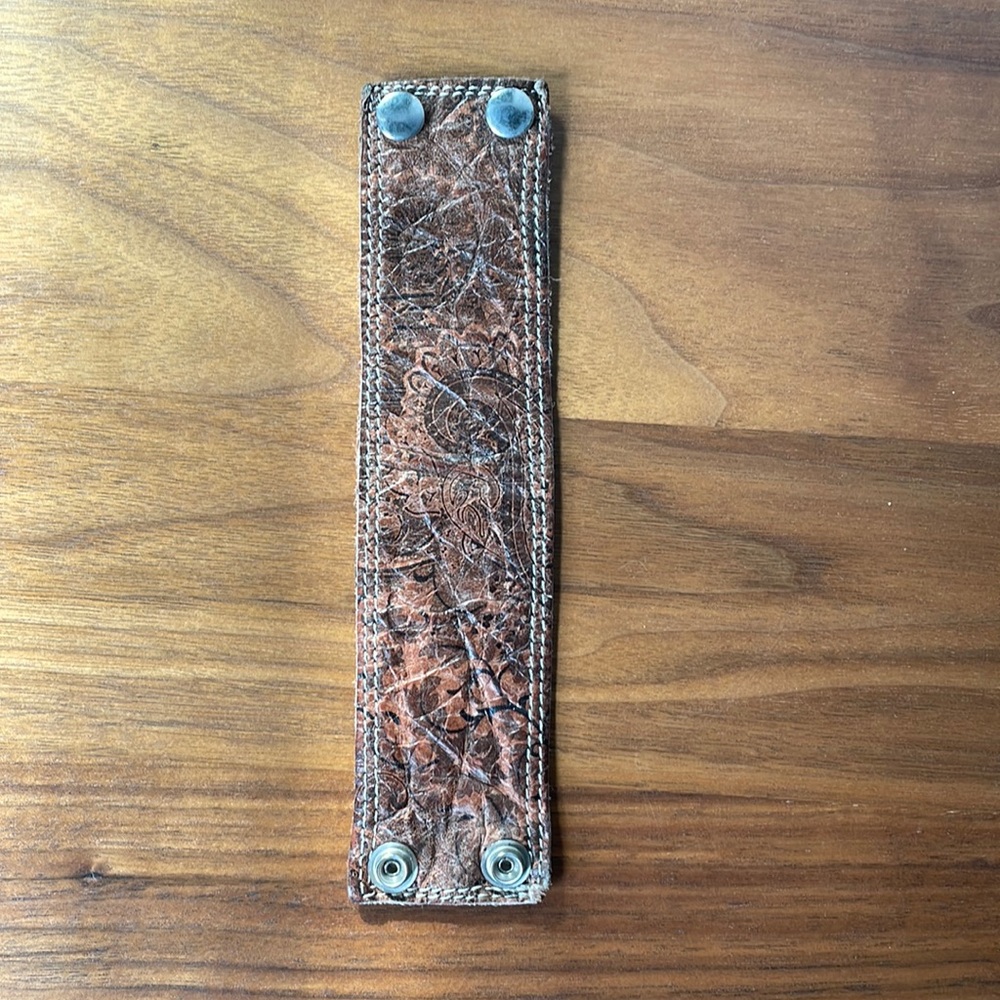 Leather paisley reversible wrist band.